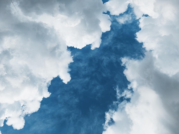 Cumulus clouds diagonally against a dark blue sky