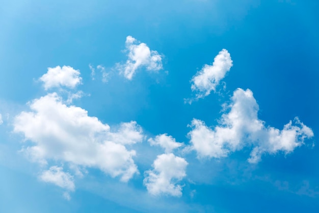 Cumulus clouds ring on a clear blue sky on a sunny day Space for text