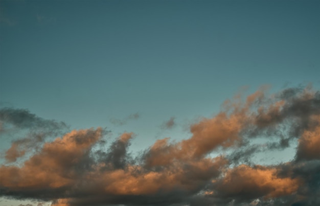 Cumulus sunset clouds with the sun setting down Amazing sky summer evening background