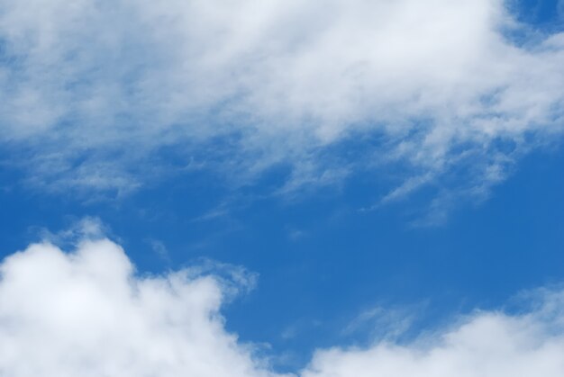 Cumulus white clouds in the dark blue sky