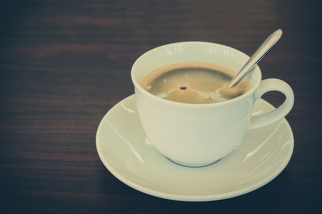 Cup of Americano coffee on wooden table