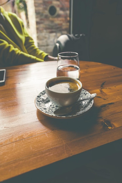 A cup of aromatic coffee on the table morning black coffee