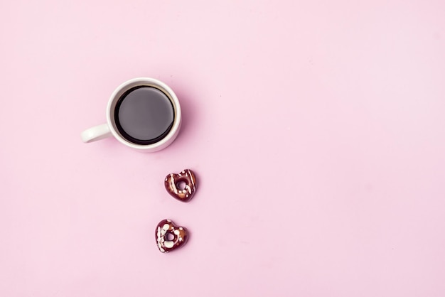 Tazza di caffè nero e due caramelle al cioccolato a forma di cuore regalo per san valentino holiday morning concept flat lay copy space festive card