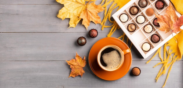 Cup of black coffee box of chocolates on an autumn background Selective focus Copy space Top view flat layout