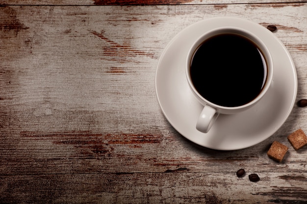 Cup of black coffee over grunge wood