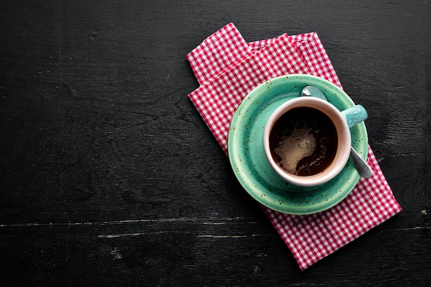 A cup of black coffee on a wooden background Free space for your text Top view