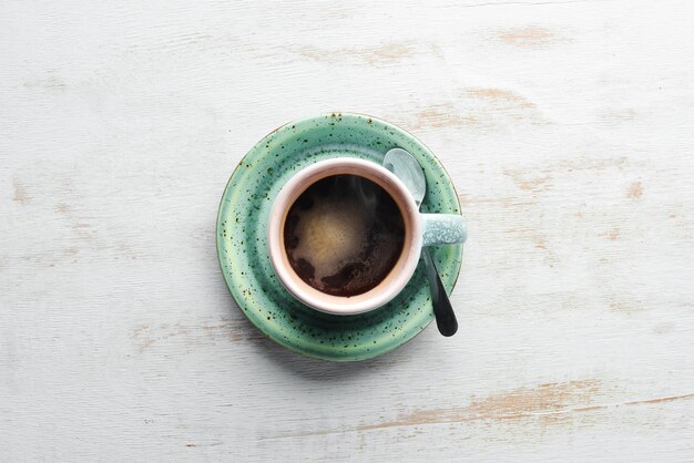 A cup of black coffee on a wooden background Free space for your text Top view