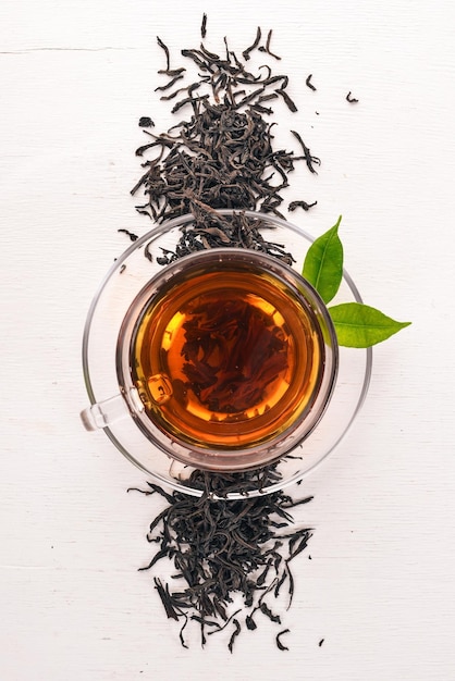 A cup of black tea on a wooden background Top view Copy space