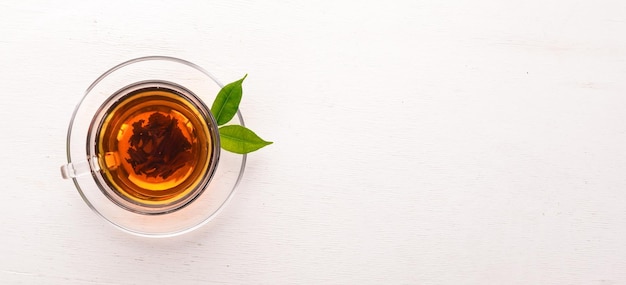 A cup of black tea on a wooden background Top view Copy space