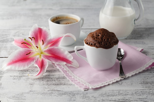 Cup cake in teacup with coffee