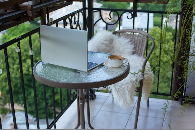 Cup of cappuccino and flowers view and working at home