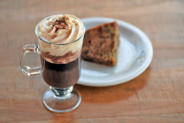 Cup of cappuccino on raw wood table