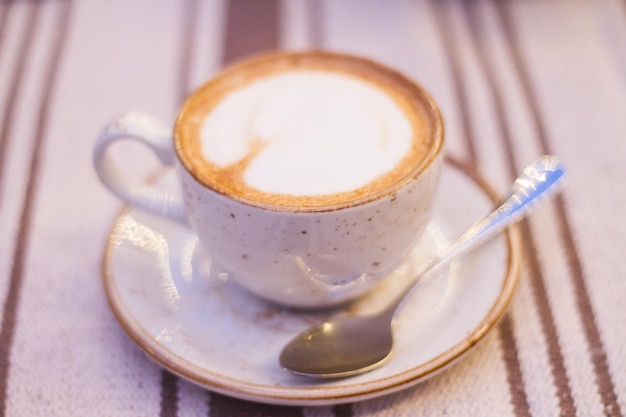 Cup of cappuccino on the table