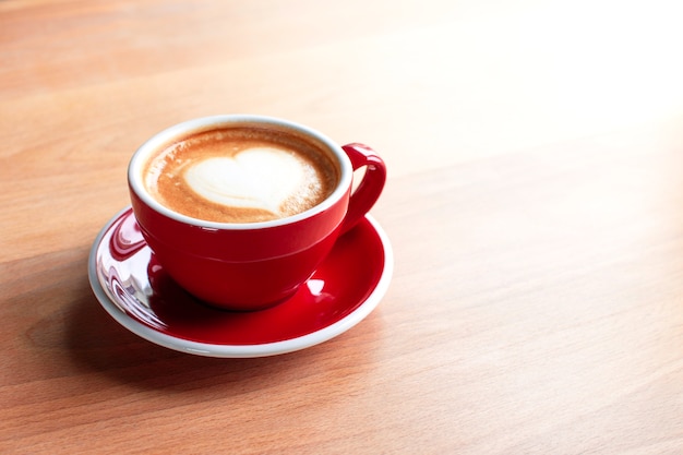 Cup of cappuccino with latte art on a wooden background