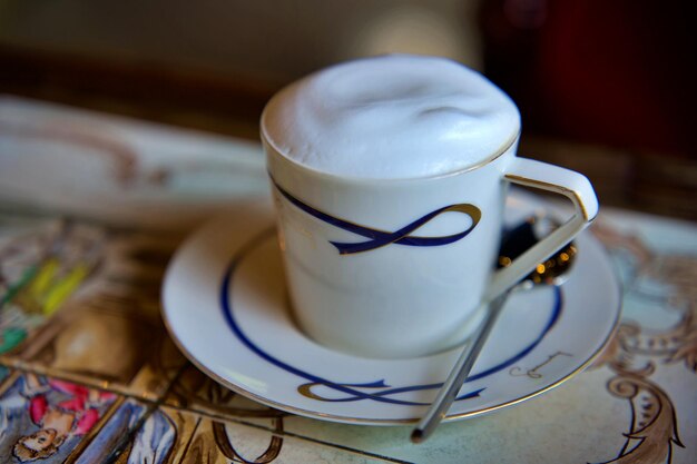 Cup of cappuccino on a wooden table in a cafe Beautiful foam white ceramic cup copy space