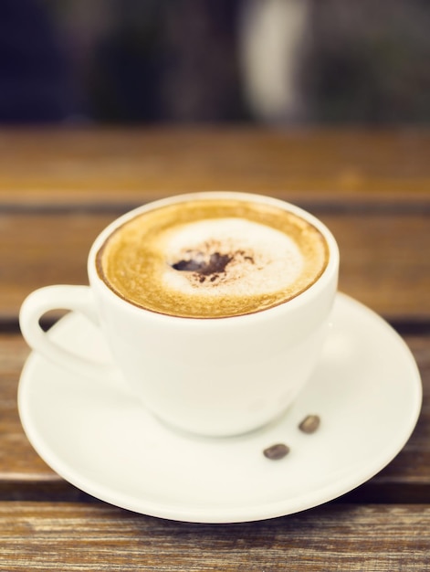 Cup of cappuccino on a wooden table