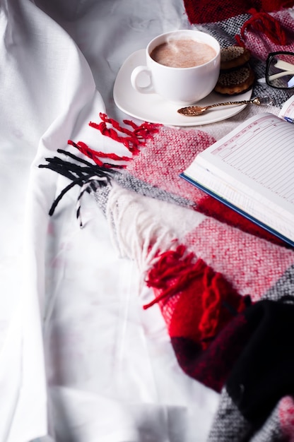 Cup of cocoa staying on open book