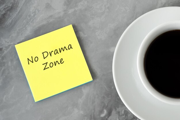 Cup of coffee and adhesive note with text Give yourself a break