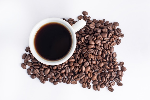 Cup of coffee arranged with fresh roasted beans