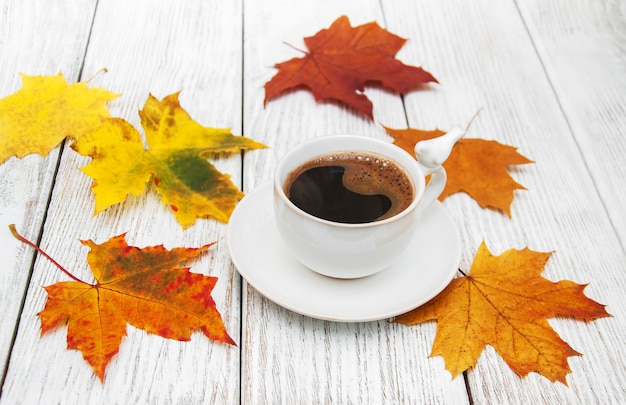 Cup of coffee and autumn leaves