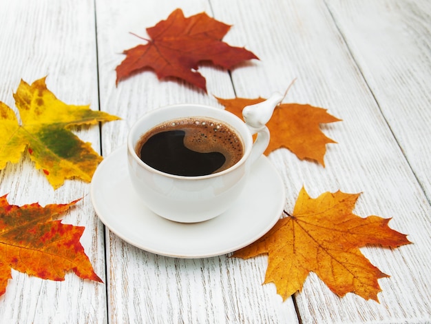 Cup of coffee and autumn leaves