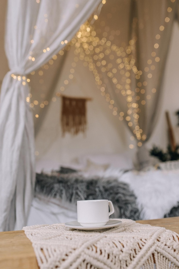 Photo cup of coffee on the background of the bed in the bedroom. vertical photo