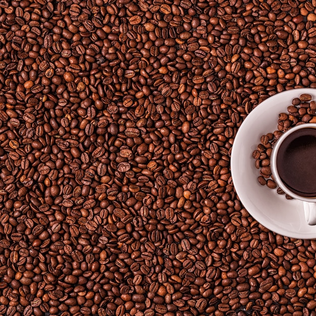 Cup of coffee on a background of coffee beans