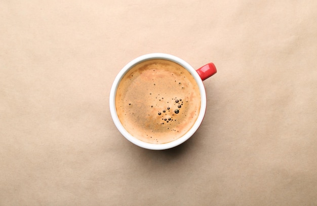 Photo cup of coffee on beige background top view