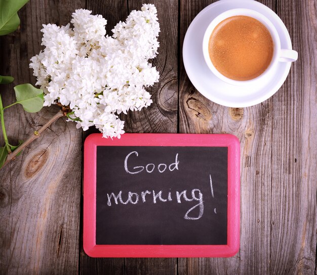 Cup of coffee and a black board 