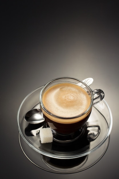 Cup of coffee on black surface