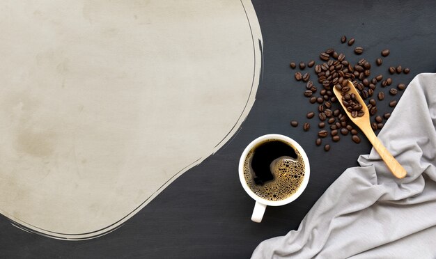 Cup of coffee on black wooden floor 