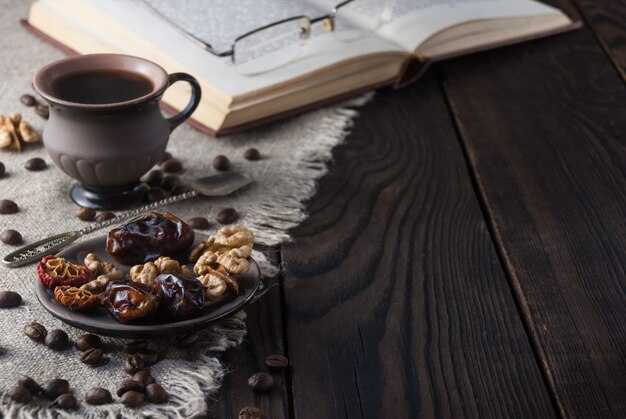 Cup of coffee and book on a wooden table