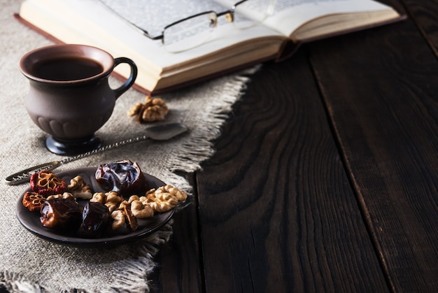 Cup of coffee and book on a wooden table