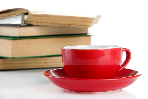 Cup of coffee and books isolated on white