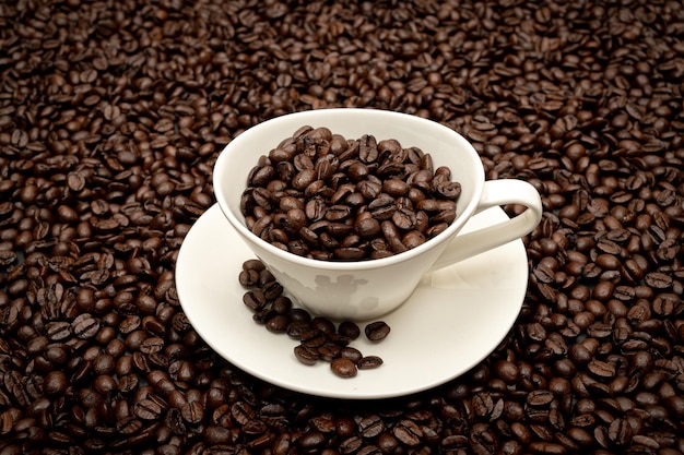 Cup of coffee on brown coffee beans