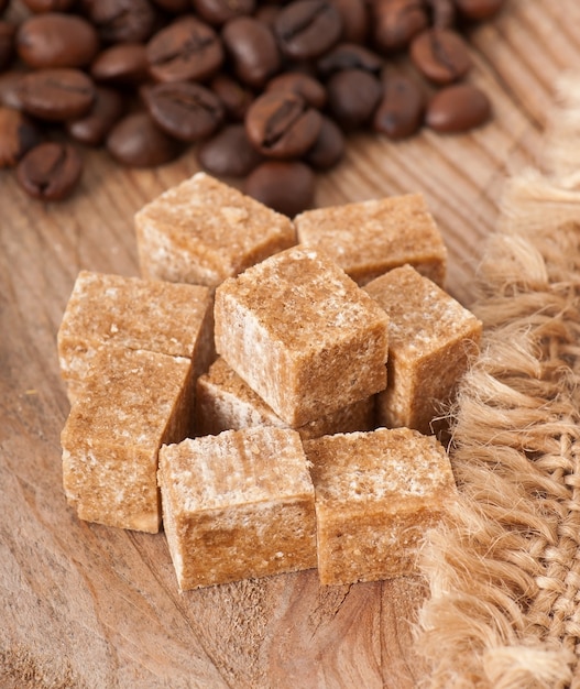 Cup of coffee, brown sugar and coffee beans