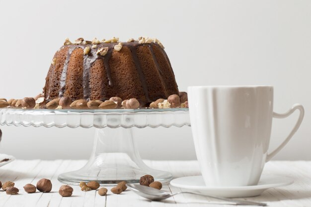 Cup of coffee and cake on wooden table