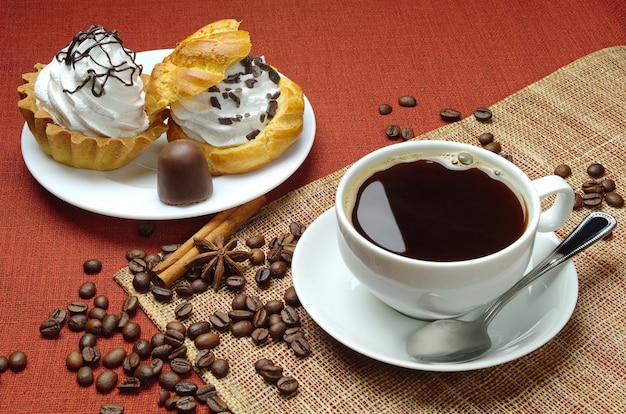 Cup of coffee and cakes on a plate