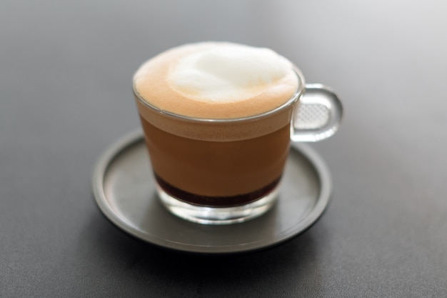 Cup of coffee. Cappuccino with foam selective focus
