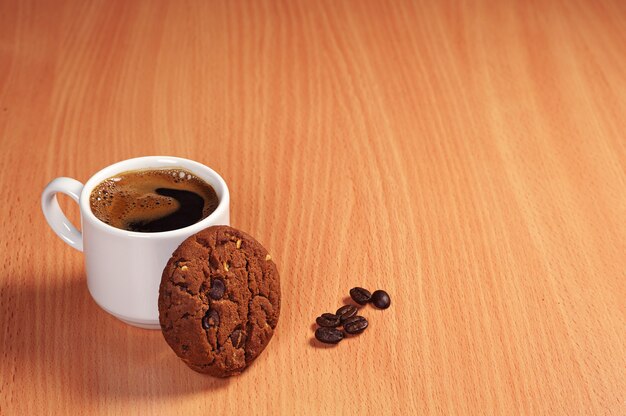 Cup of coffee and chocolate cookies with nuts