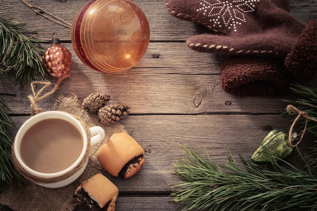 Cup of coffee and Christmas decoration on wooden table