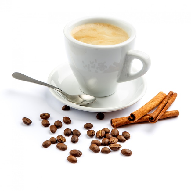 Cup of coffee and cinnamon on white background