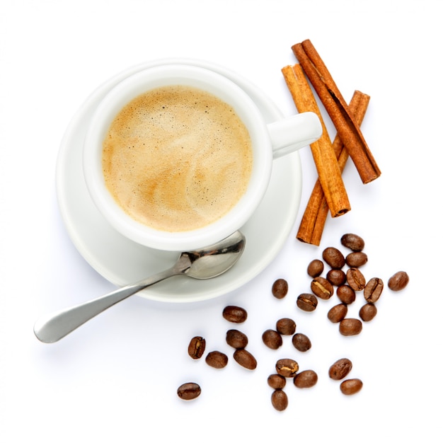 Cup of coffee and cinnamon on white background