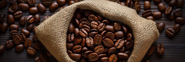 Cup of coffee and coffee beans in a sack top view