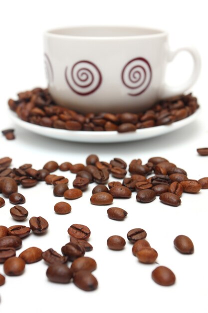 Cup of coffee and coffee beans on a white background