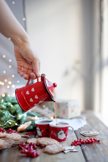 a cup of coffee and a coffee pot, berries and cookies