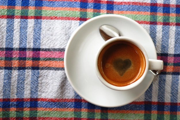 Cup of coffee on a colorful tablecloth