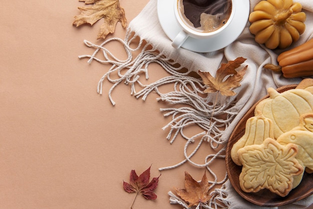 Cup of coffee cookies on tray yellow leaves