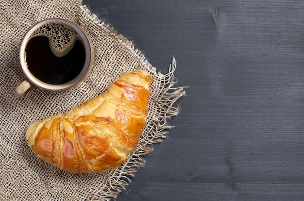 Cup of coffee and croissant