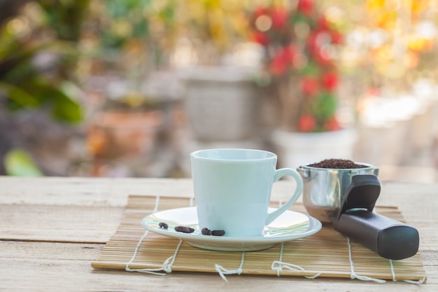 Photo cup of coffee on disk and coffee scoop